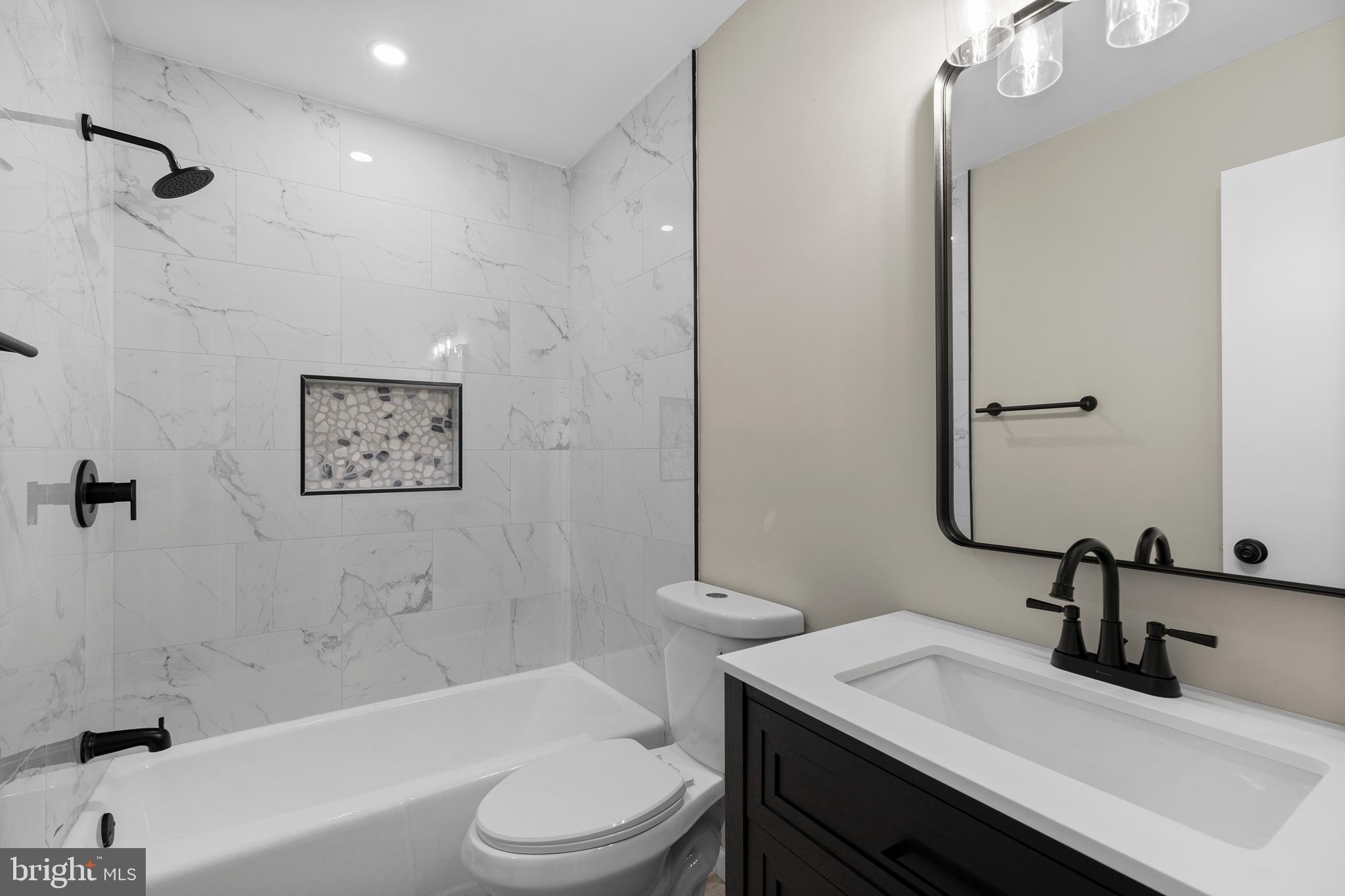 7517 Todd Place Manassas, VA 20109 - Photo 7 of 42 a bathroom with a sink a toilet and shower