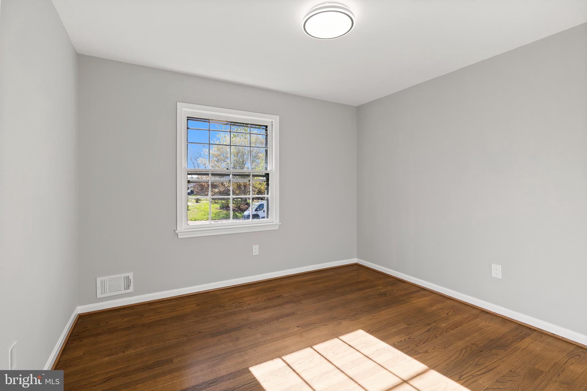 7517 Todd Place Manassas, VA 20109 - Photo 9 of 42 an empty room with wooden floor and windows