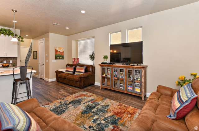1622 Canyon Tree Drive St. George, UT 84770 - Photo 6 of 34 Open-concept living area with wood-finish flooring, recessed lighting, and neutral wall tones