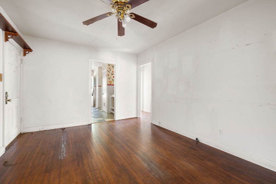 4419 Clawson Road Austin, TX 78704 - Photo 11 of 24 an empty room with wooden floor chandelier fan and windows