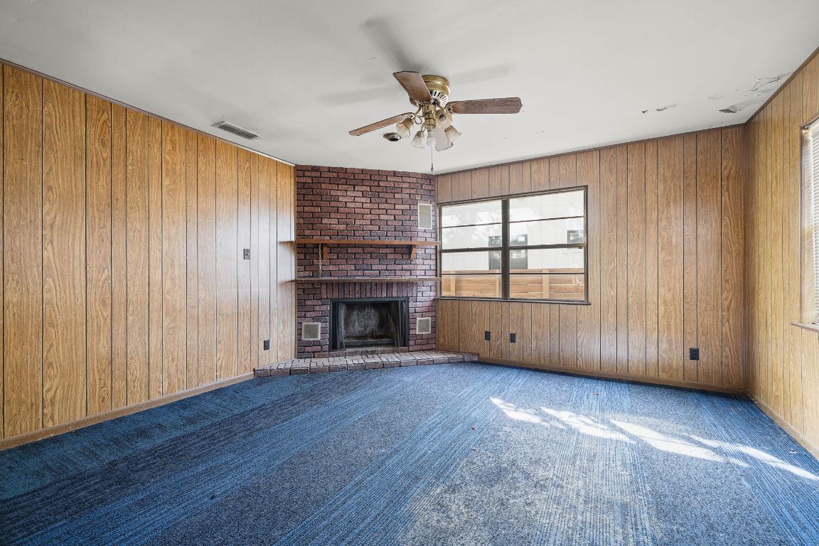 4419 Clawson Road Austin, TX 78704 - Photo 12 of 24 an empty room with windows fireplace and wooden floor