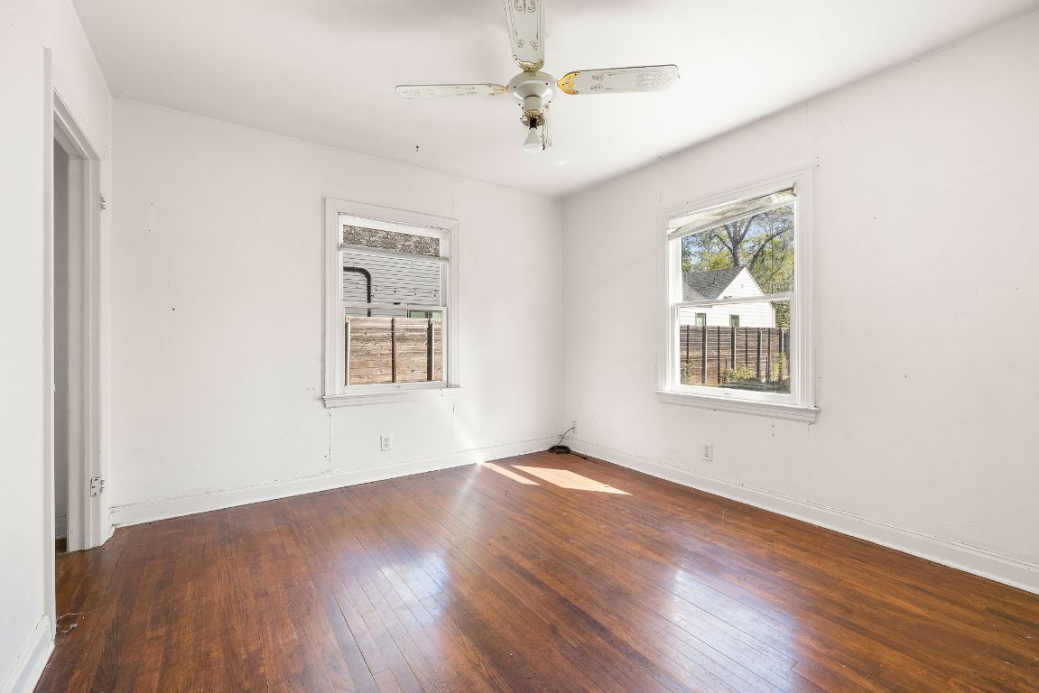 4419 Clawson Road Austin, TX 78704 - Photo 18 of 24 an empty room with wooden floor chandelier fan and windows