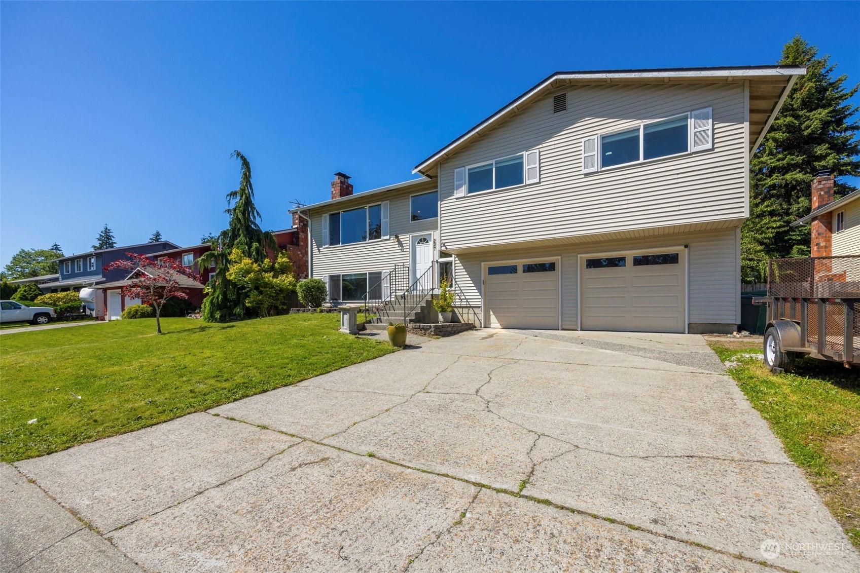 227 214th Street Southwest Bothell, WA 98021 - Photo 1 of 1 a front view of a house with a yard and garage