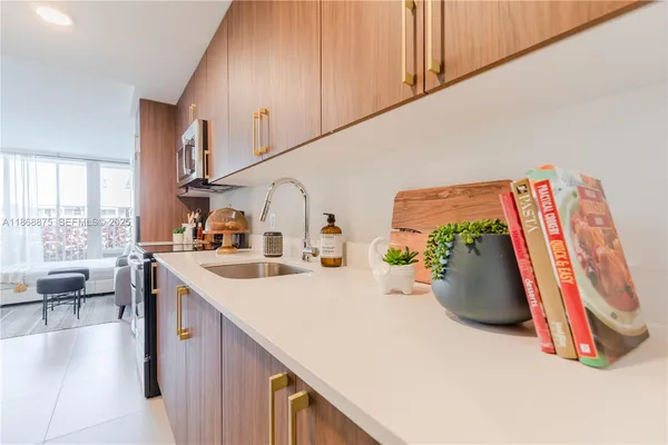 a view of a kitchen with furniture and a potted plant