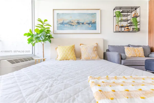 a bedroom with a bed and a painting on the wall