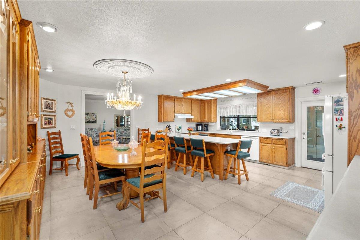 4616 Freelove Road Oakdale, CA 95361 - Photo 14 of 86 a view of a dining area with furniture and chandelier