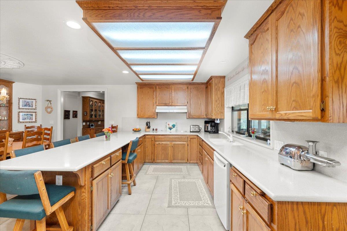 4616 Freelove Road Oakdale, CA 95361 - Photo 18 of 86 a large kitchen with kitchen island a large window a sink and stainless steel appliances