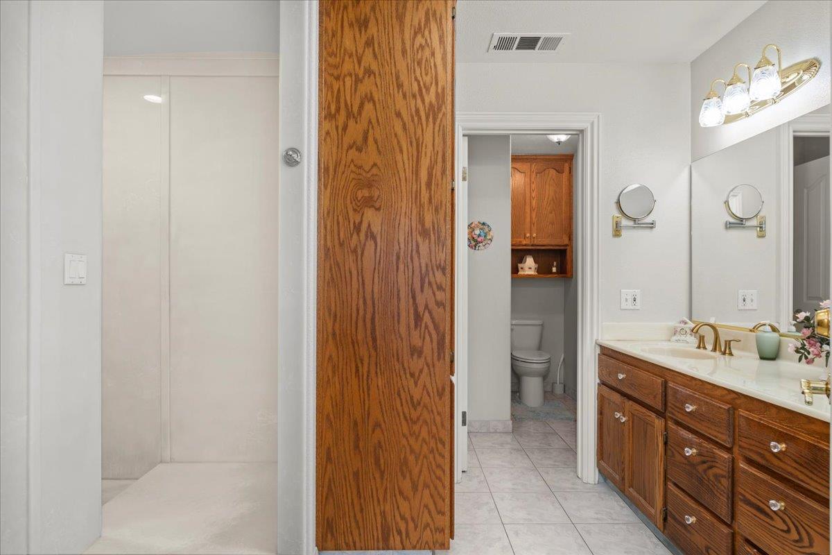 4616 Freelove Road Oakdale, CA 95361 - Photo 31 of 86 a bathroom with a shower sink and mirror