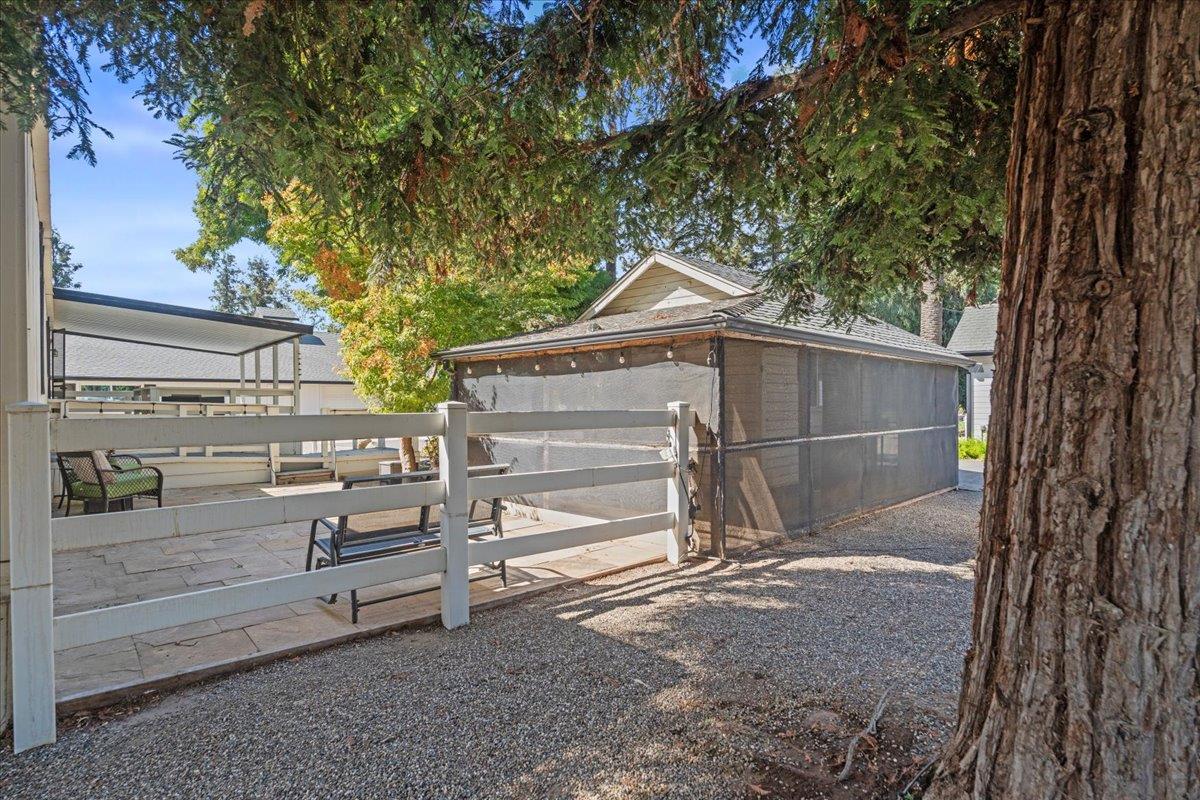 4616 Freelove Road Oakdale, CA 95361 - Photo 62 of 86 a view of backyard with small cabin and wooden fence