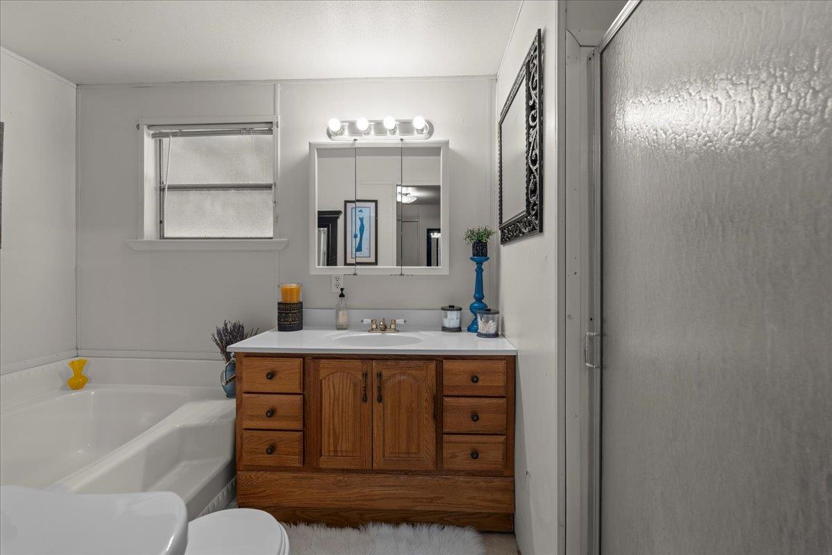 4616 Freelove Road Oakdale, CA 95361 - Photo 70 of 86 a bathroom with a tub sink and mirror