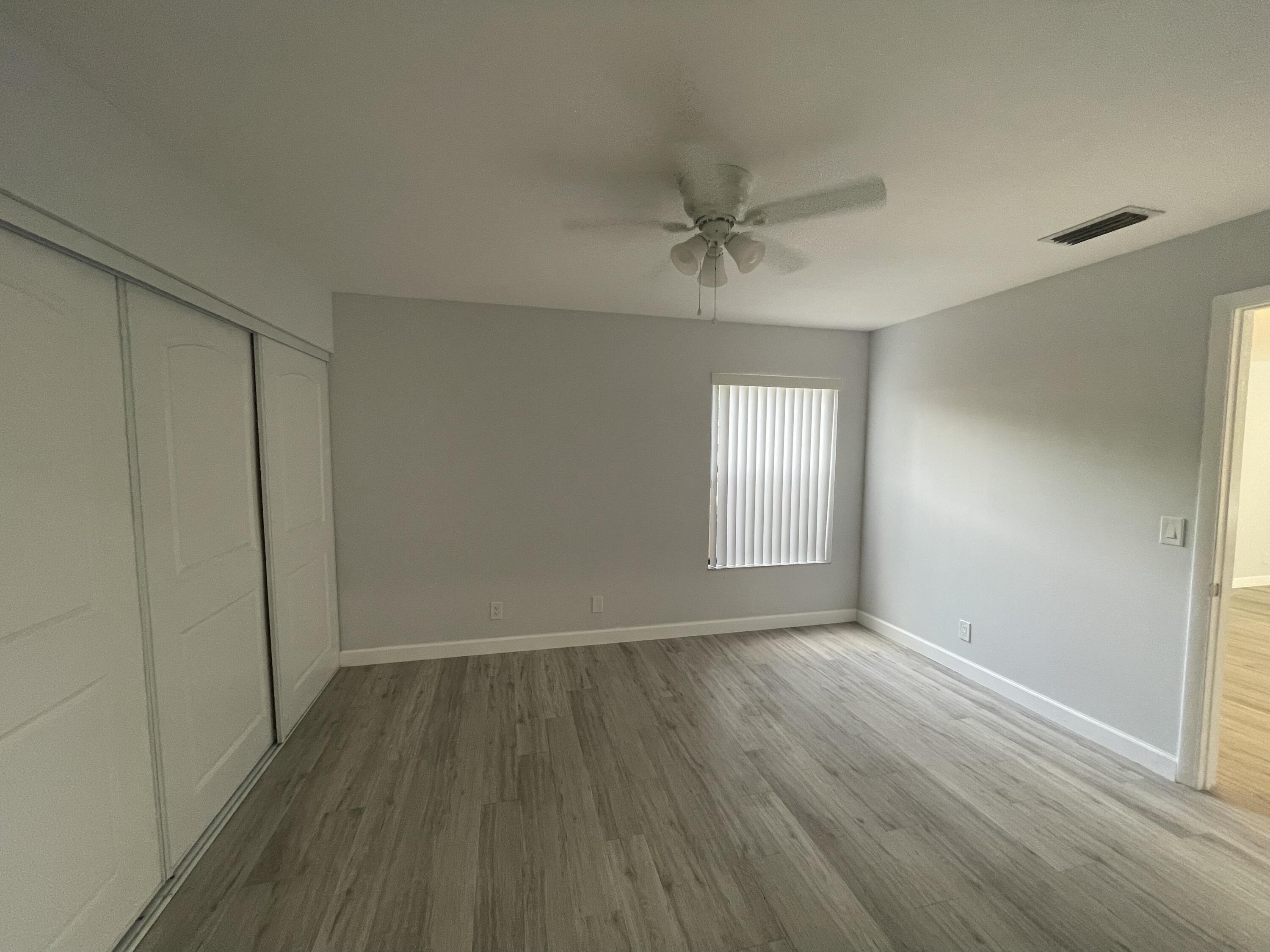 3 Crossings Circle, Unit A Boynton Beach, FL 33435 - Photo 11 of 21 a view of an empty room with a window and wooden floor