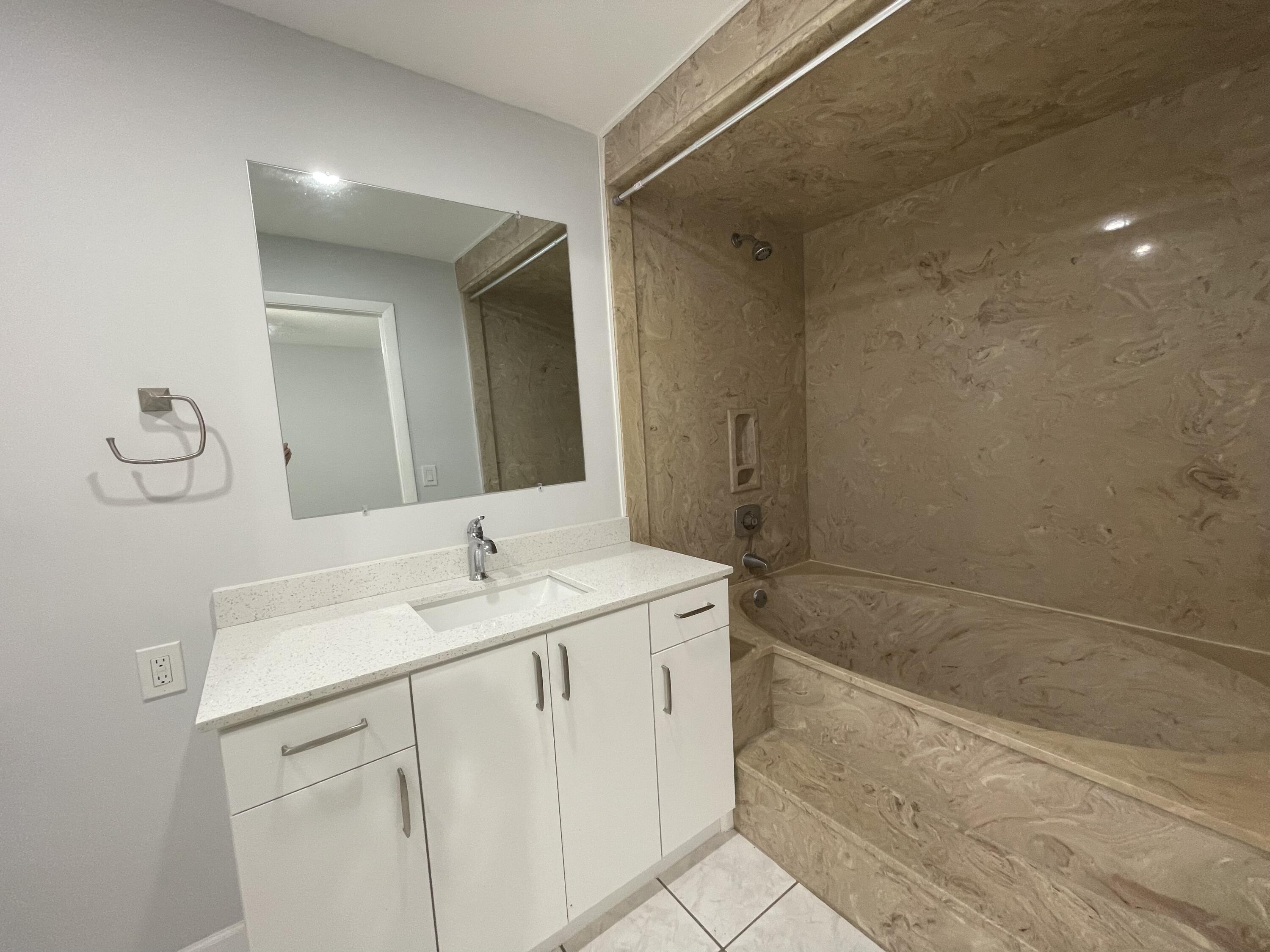 3 Crossings Circle, Unit A Boynton Beach, FL 33435 - Photo 7 of 21 a bathroom with a sink a vanity and a mirror