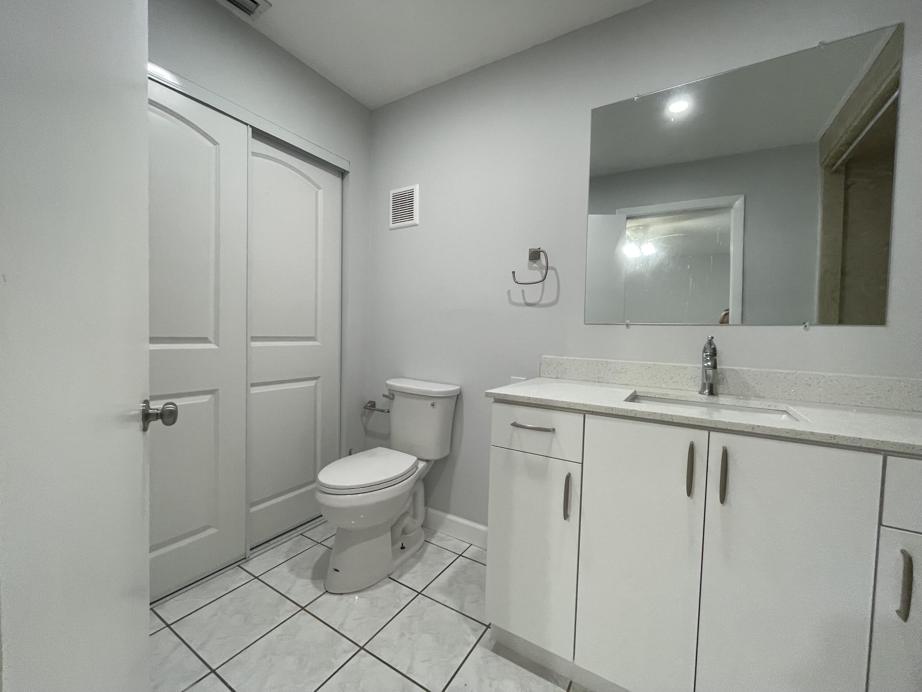 3 Crossings Circle, Unit A Boynton Beach, FL 33435 - Photo 8 of 21 a bathroom with a toilet sink and mirror