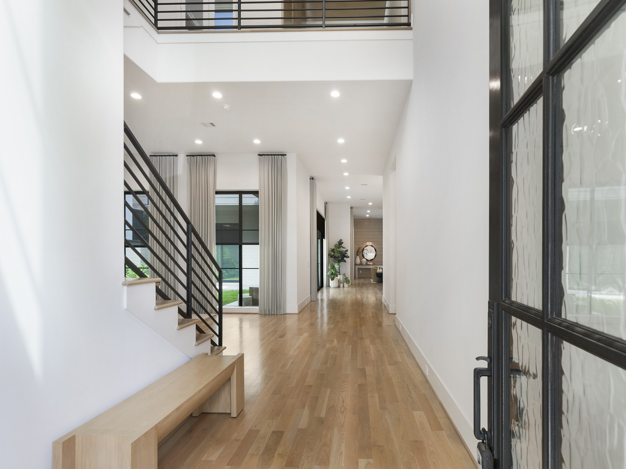 4024 Chatham Lane Houston, TX 77027 - Photo 3 of 50 a hallway with wooden floor and staircase