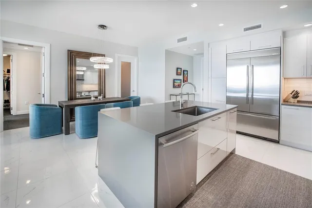 a bathroom with a granite countertop toilet sink and mirror