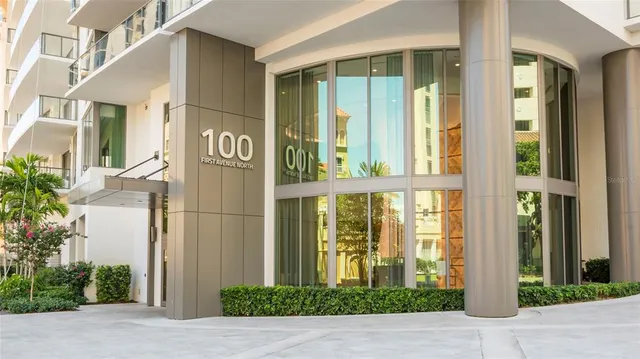 a kitchen with stainless steel appliances granite countertop a sink a stove a refrigerator a dining table and chairs