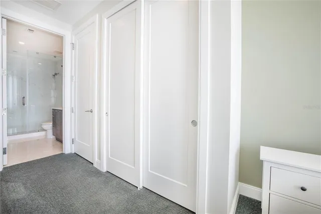 a white toilet sitting next to a white sink