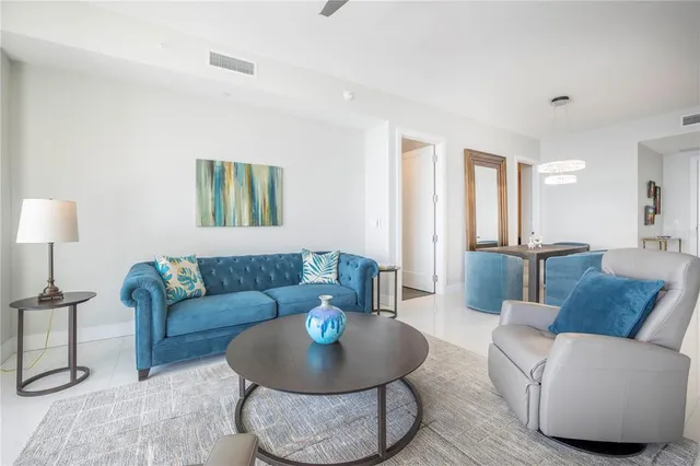 a kitchen with stainless steel appliances granite countertop a stove top oven a sink and a refrigerator