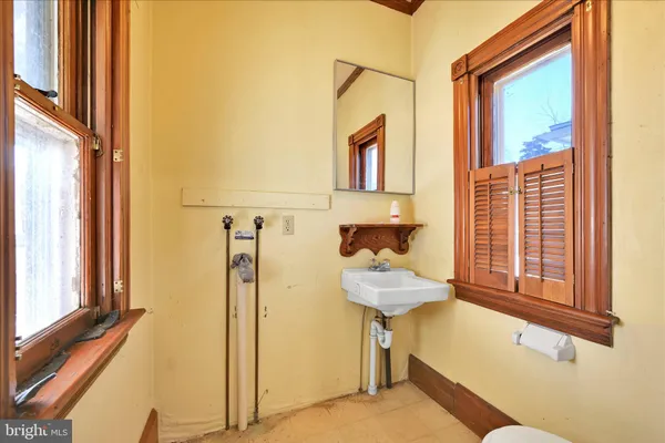 a large kitchen with kitchen island granite countertop a sink stainless steel appliances and window