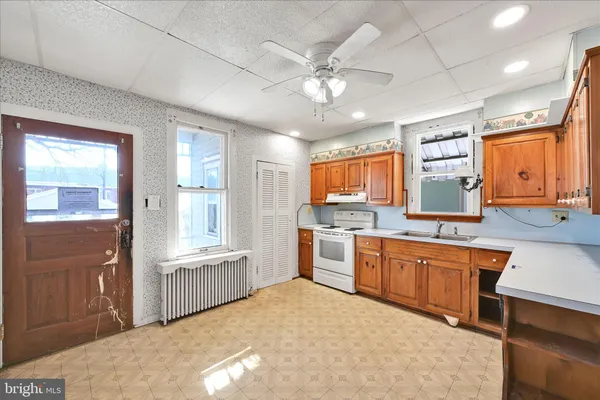 a kitchen with a stove a sink and a refrigerator