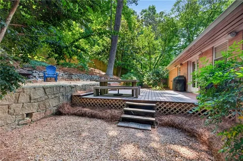 a view of a house with backyard and sitting area