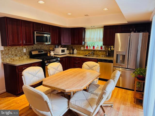 632 Longfellow Court Warminster, PA 18974 - Photo 5 of 30 a kitchen with stainless steel appliances granite countertop a refrigerator a stove a sink dishwasher a dining table and chairs with wooden floor