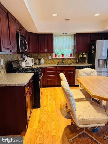 a kitchen with a sink appliances and cabinets