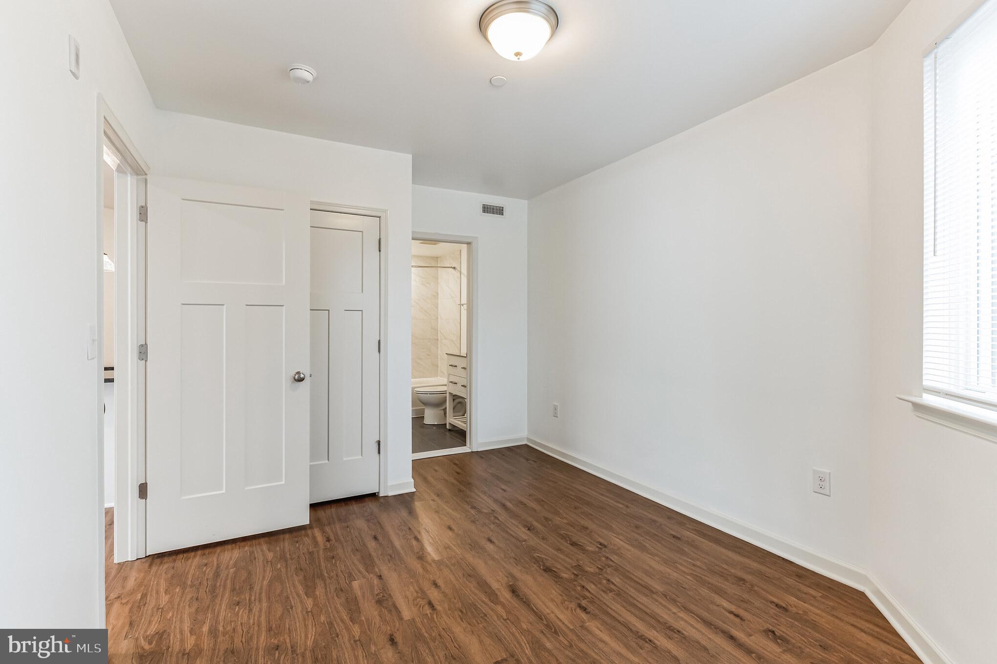 6157-61 Ridge Avenue, Unit 201 Philadelphia, PA 19128 - Photo 9 of 10 an empty room with wooden floor and windows