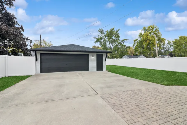 a front view of a house with a yard and trees