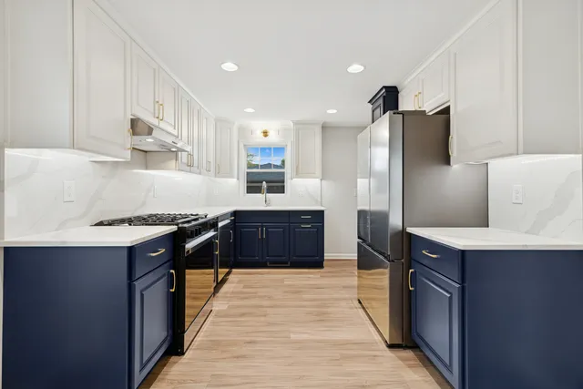a kitchen with stainless steel appliances granite countertop a stove a sink dishwasher a refrigerator and a oven