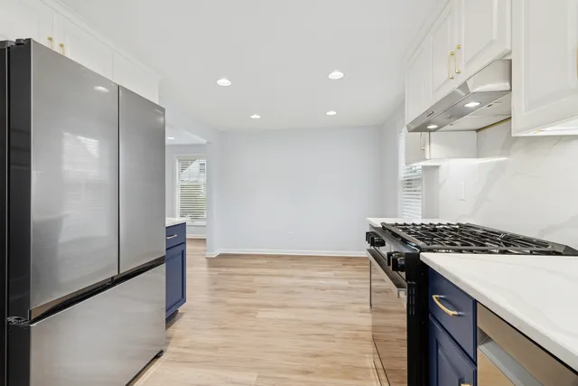 a kitchen with a stove and a refrigerator