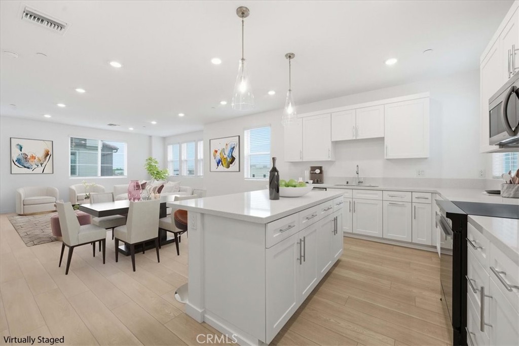 9335 Via Azul Pico Rivera, CA 90660 - Photo 16 of 55 a kitchen with cabinets and chairs