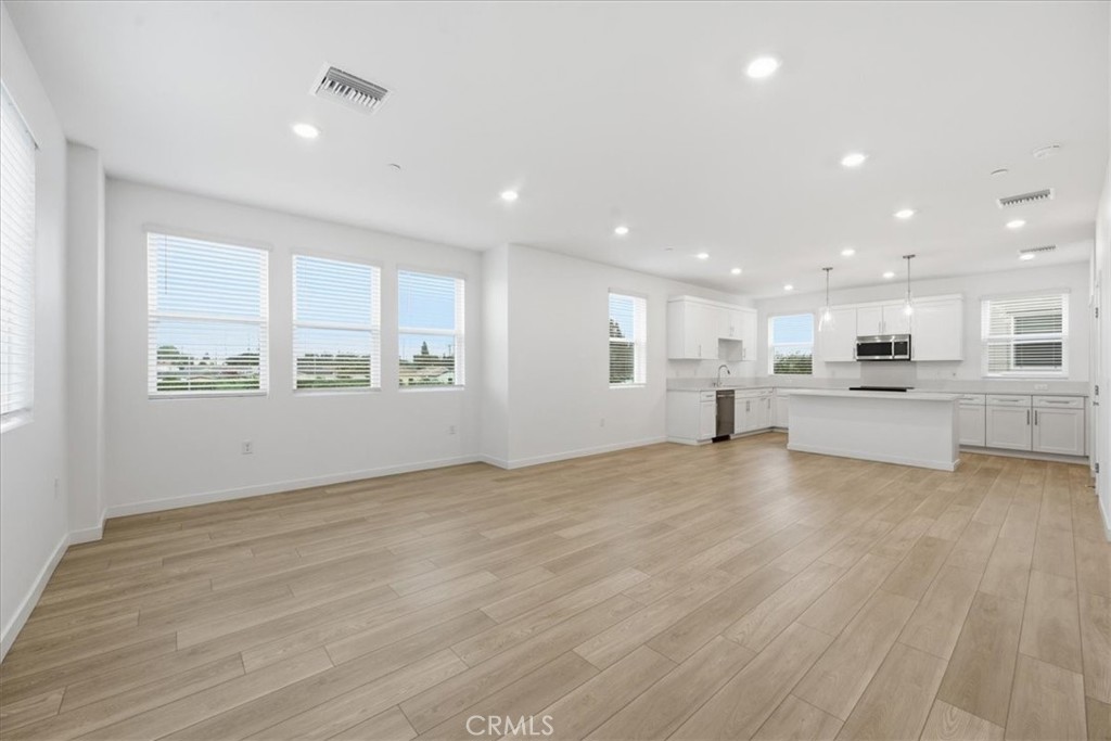 9335 Via Azul Pico Rivera, CA 90660 - Photo 21 of 55 a view of an empty room with a window and wooden floor