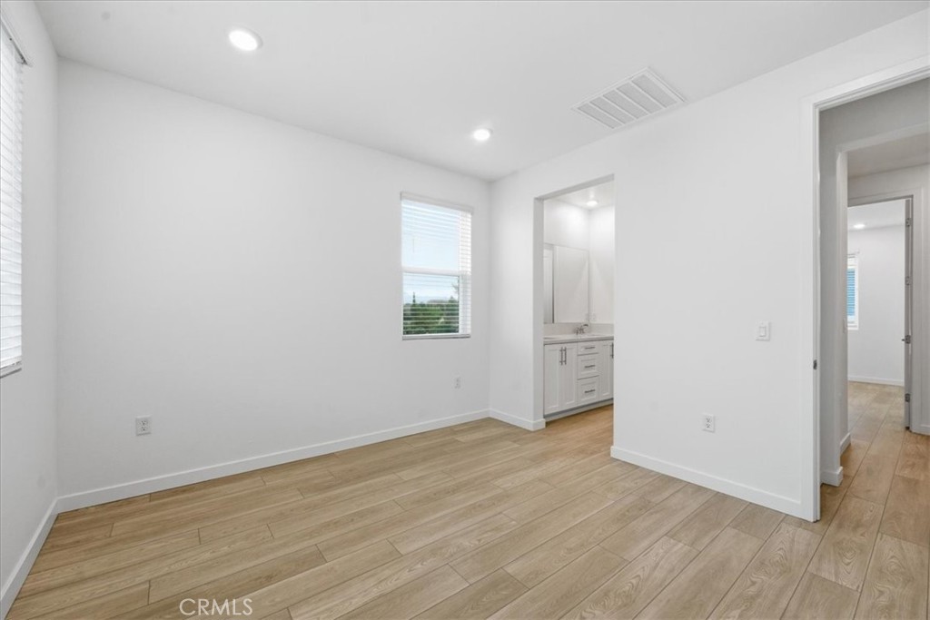 9335 Via Azul Pico Rivera, CA 90660 - Photo 32 of 55 an empty room with wooden floor and windows