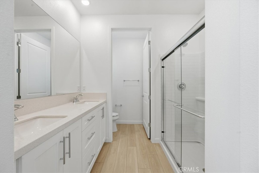 9335 Via Azul Pico Rivera, CA 90660 - Photo 39 of 55 a bathroom with a double vanity sink and mirror
