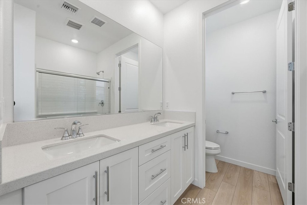 9335 Via Azul Pico Rivera, CA 90660 - Photo 41 of 55 a bathroom with a granite countertop sink a toilet and a mirror
