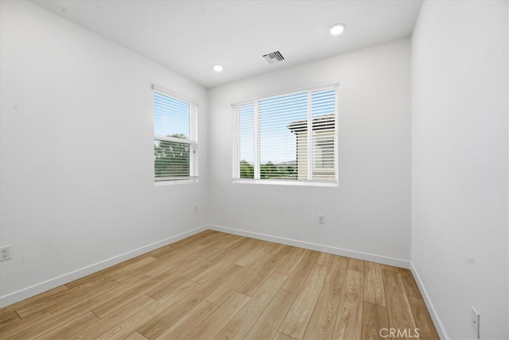 9335 Via Azul Pico Rivera, CA 90660 - Photo 42 of 55 an empty room with wooden floor and windows