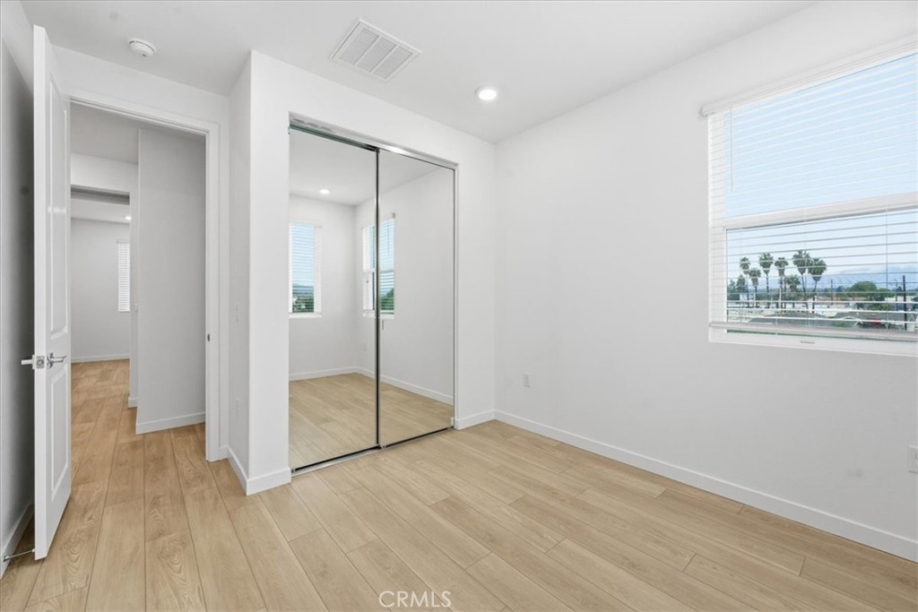 9335 Via Azul Pico Rivera, CA 90660 - Photo 44 of 55 an empty room with wooden floor mirror and windows