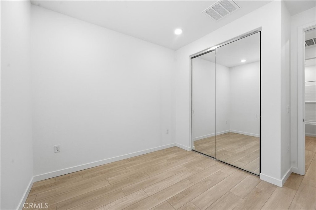 9335 Via Azul Pico Rivera, CA 90660 - Photo 48 of 55 an empty room with wooden floor and door