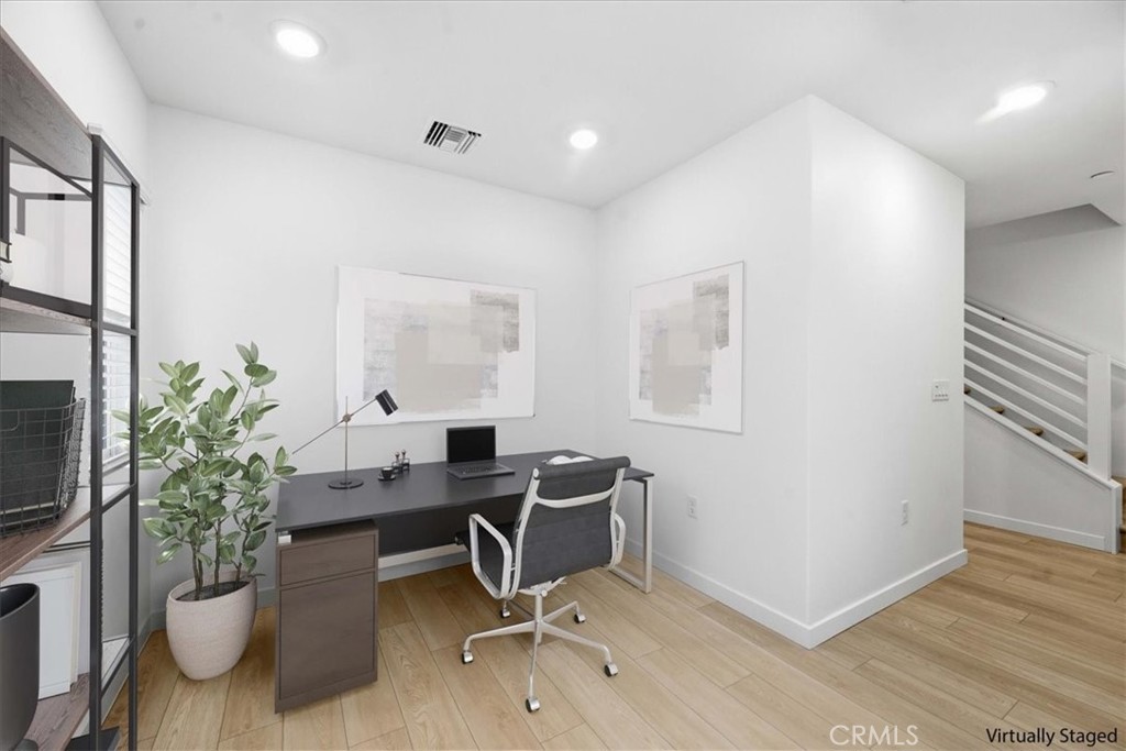 9335 Via Azul Pico Rivera, CA 90660 - Photo 5 of 55 a view of a workspace with furniture and a potted plant