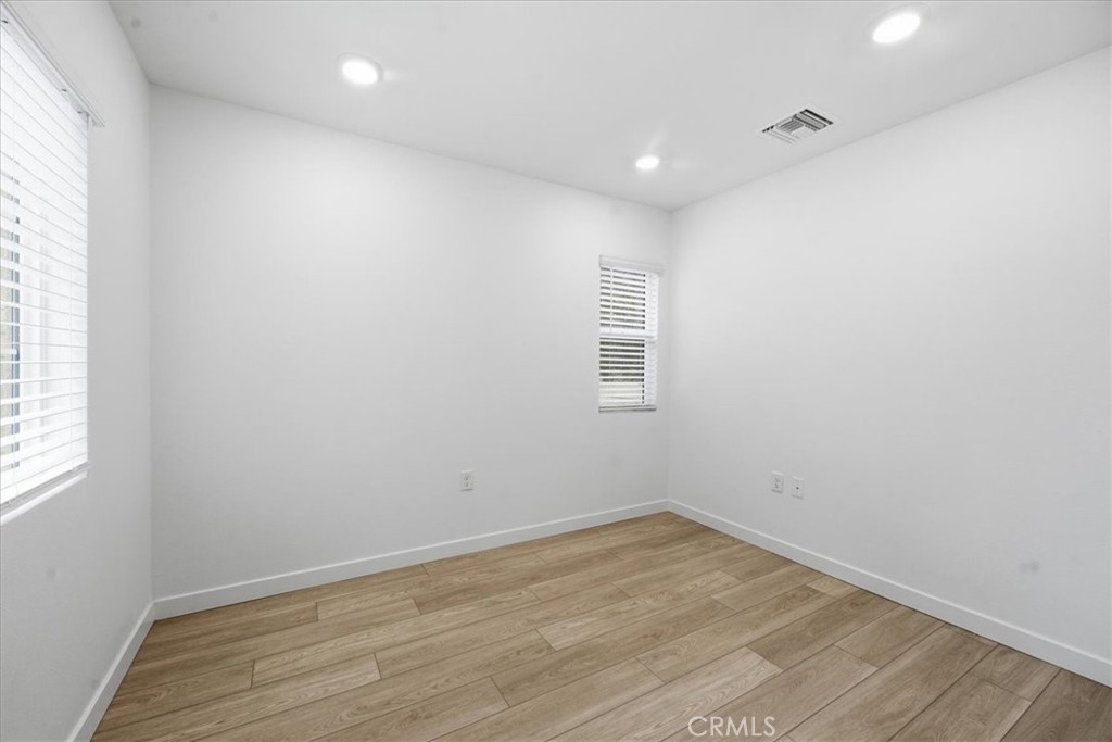 9335 Via Azul Pico Rivera, CA 90660 - Photo 6 of 55 an empty room with wooden floor and windows