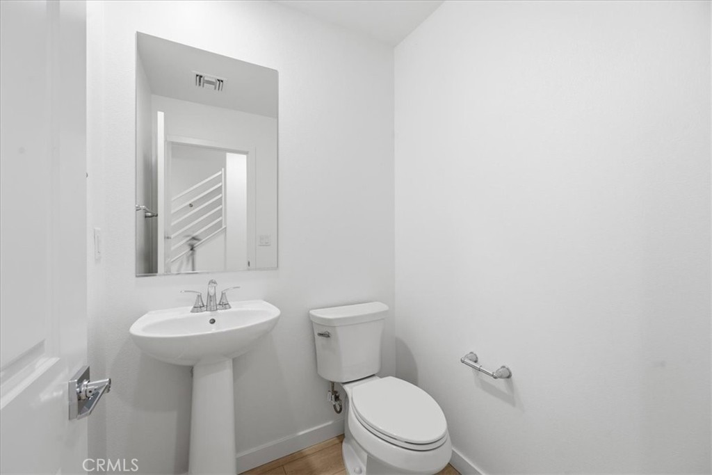 9335 Via Azul Pico Rivera, CA 90660 - Photo 8 of 55 a bathroom with a sink a toilet and mirror