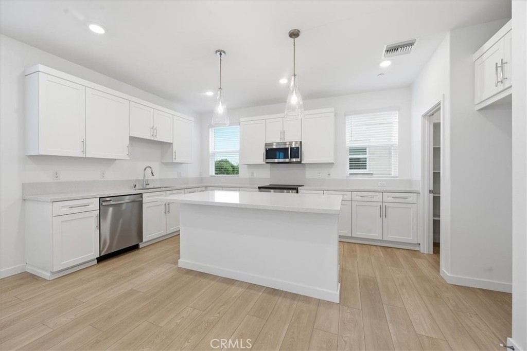 9335 Via Azul Pico Rivera, CA 90660 - Photo 9 of 55 a kitchen with a white cabinets and window