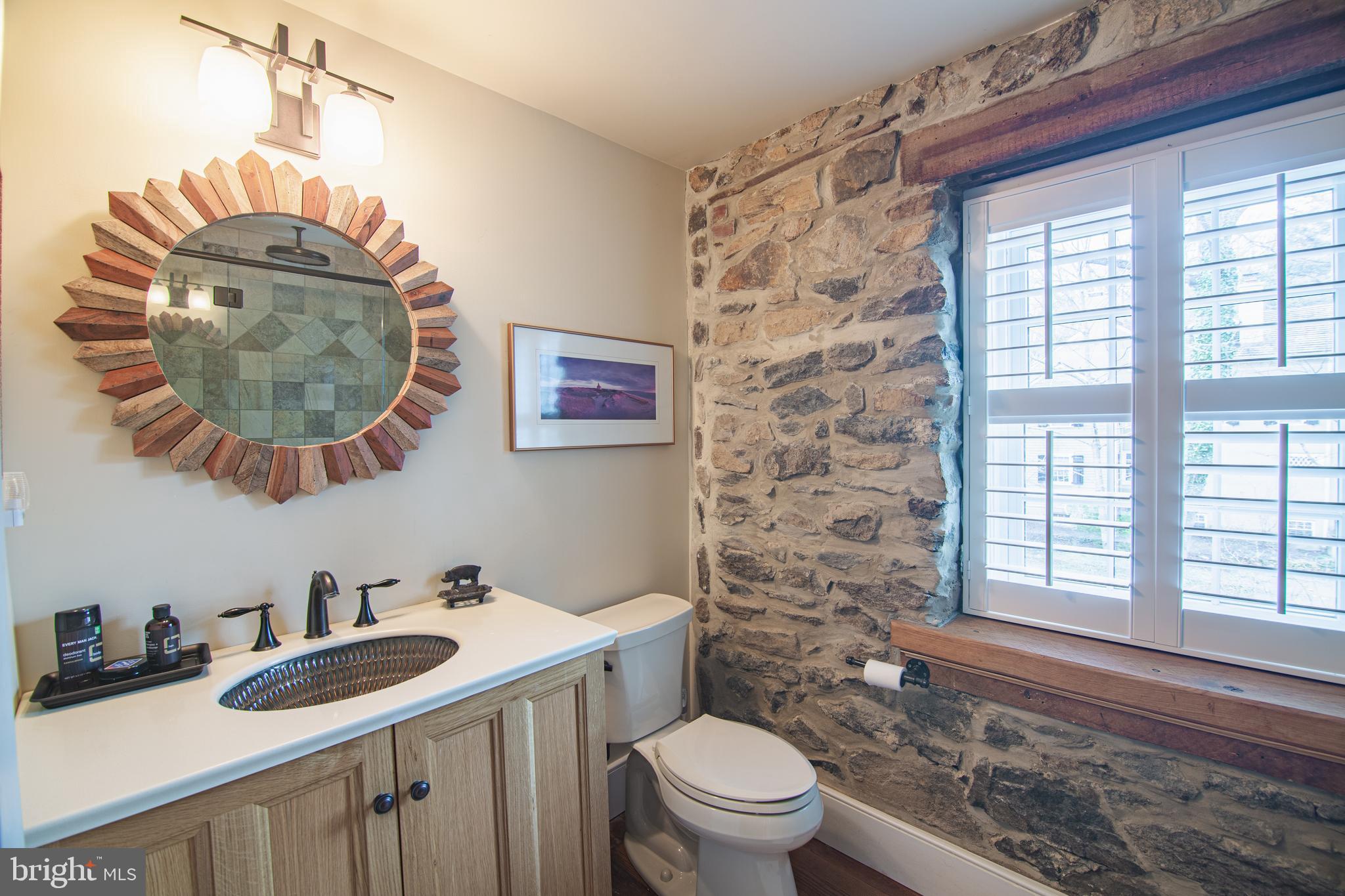 613 South Valley Forge Road Wayne, PA 19087 - Photo 24 of 43 a bathroom with a sink a toilet and a mirror