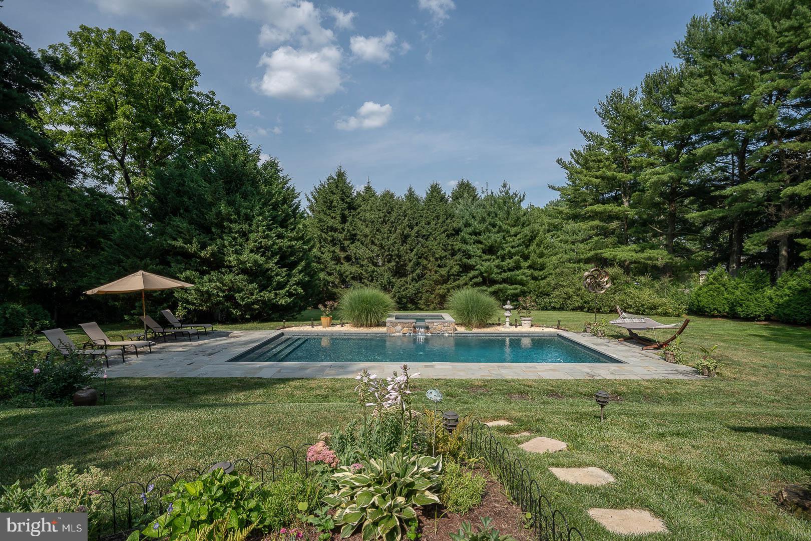 613 South Valley Forge Road Wayne, PA 19087 - Photo 3 of 43 a view of a backyard with lawn chairs under an umbrella