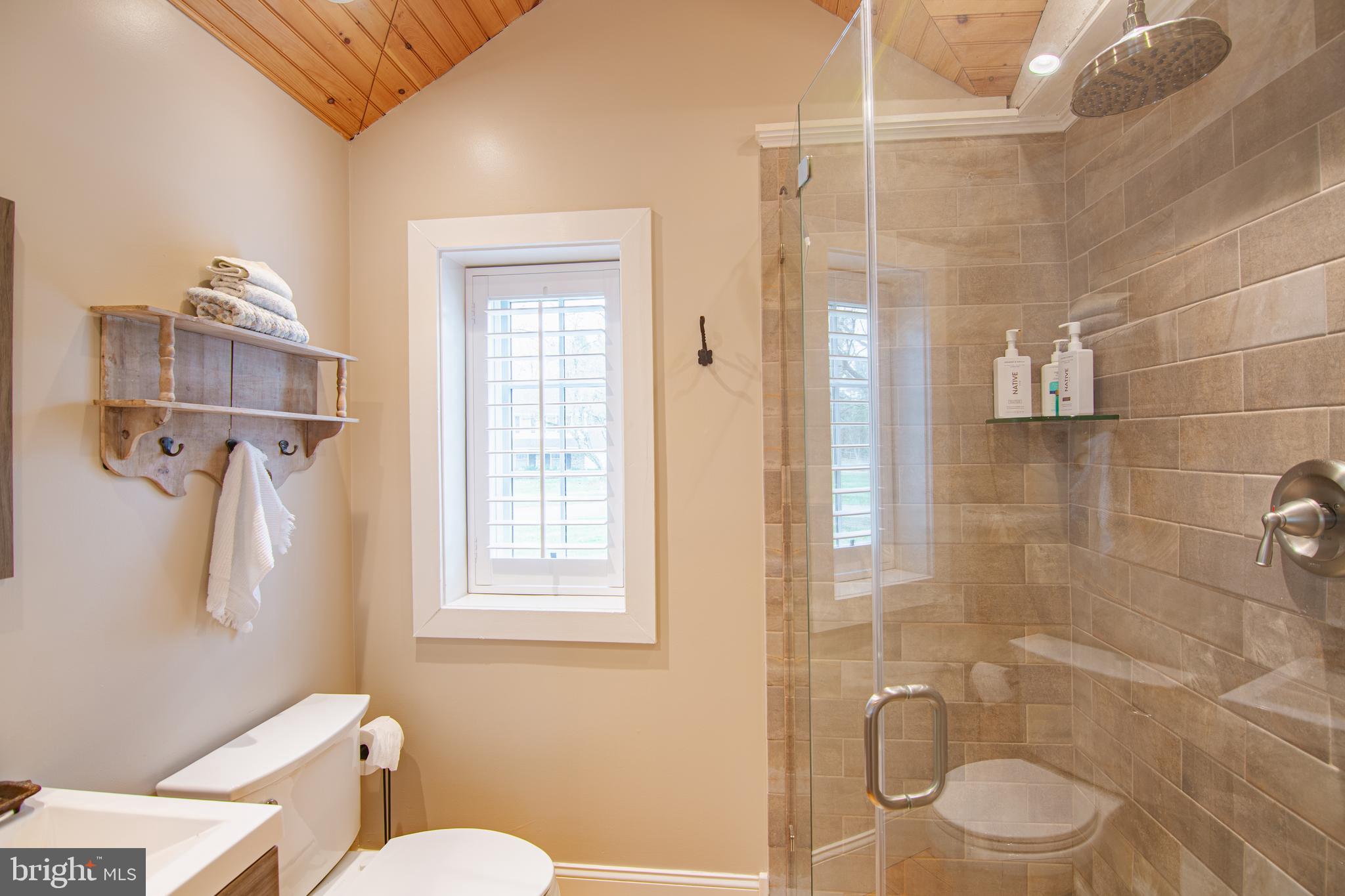 613 South Valley Forge Road Wayne, PA 19087 - Photo 33 of 43 a bathroom with a granite countertop toilet a sink a shower and a mirror