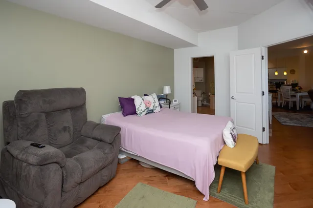 a bedroom with furniture and a rug