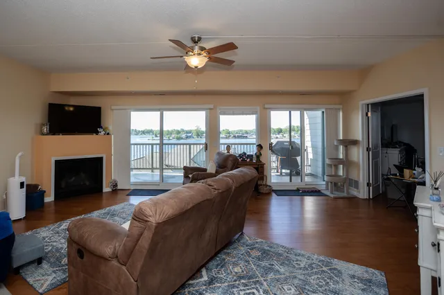 a living room with fireplace furniture and a wooden floor
