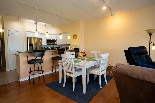 a kitchen with a table chairs and a refrigerator