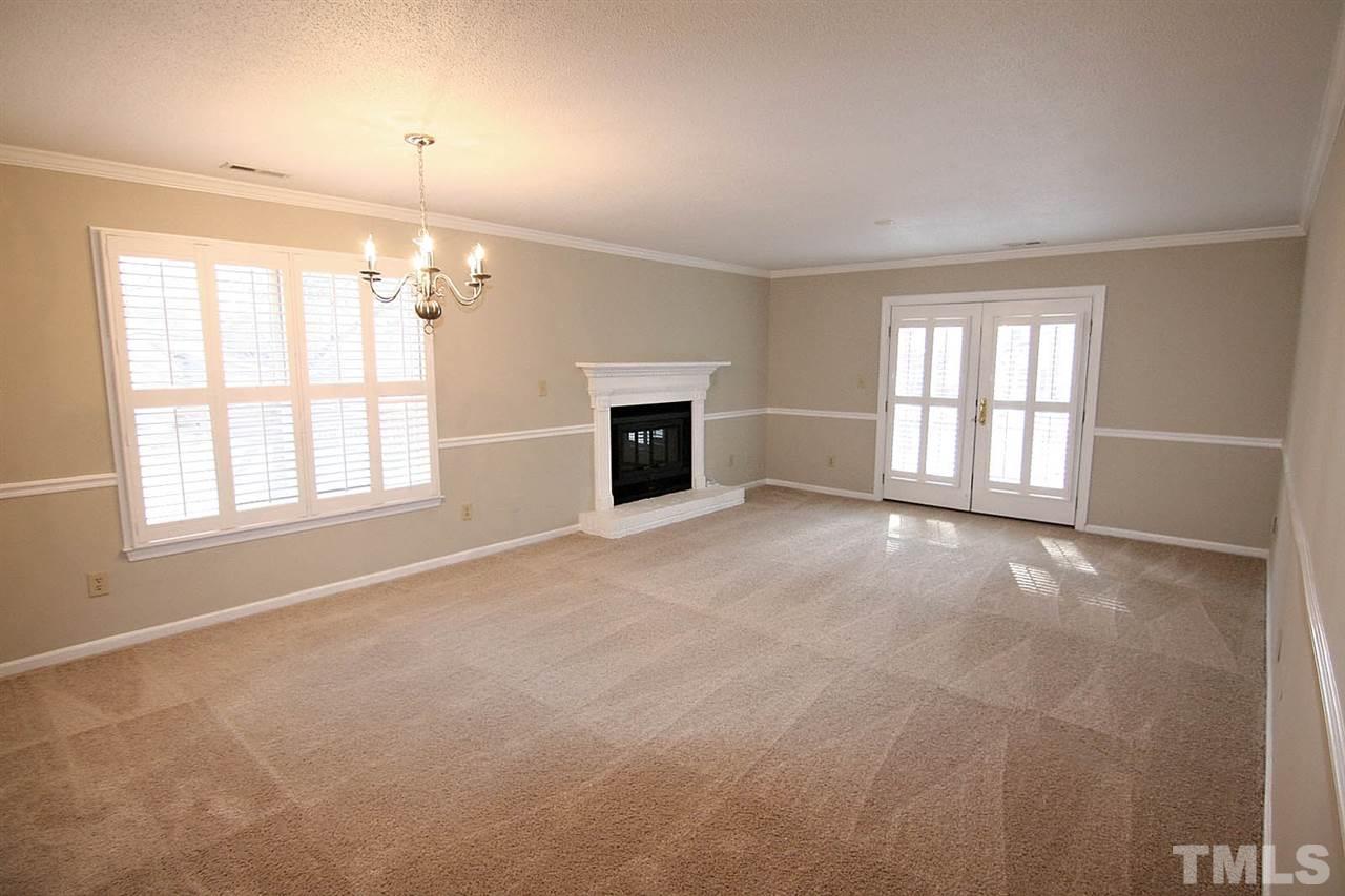 1581 Laureldale Drive Raleigh, NC 27609 - Photo 8 of 21 an empty room with windows and fireplace